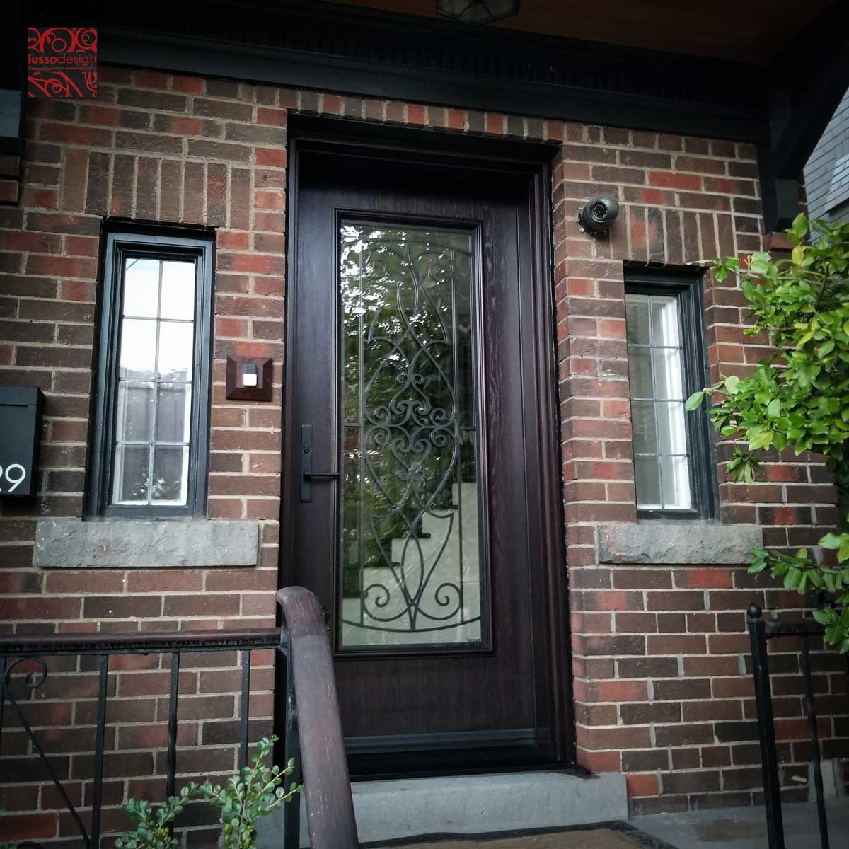 Single fiberglass door with clear glass and custom metal work